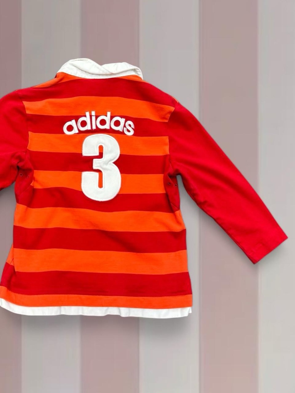 Adidas’s polo shirt, red orange striped